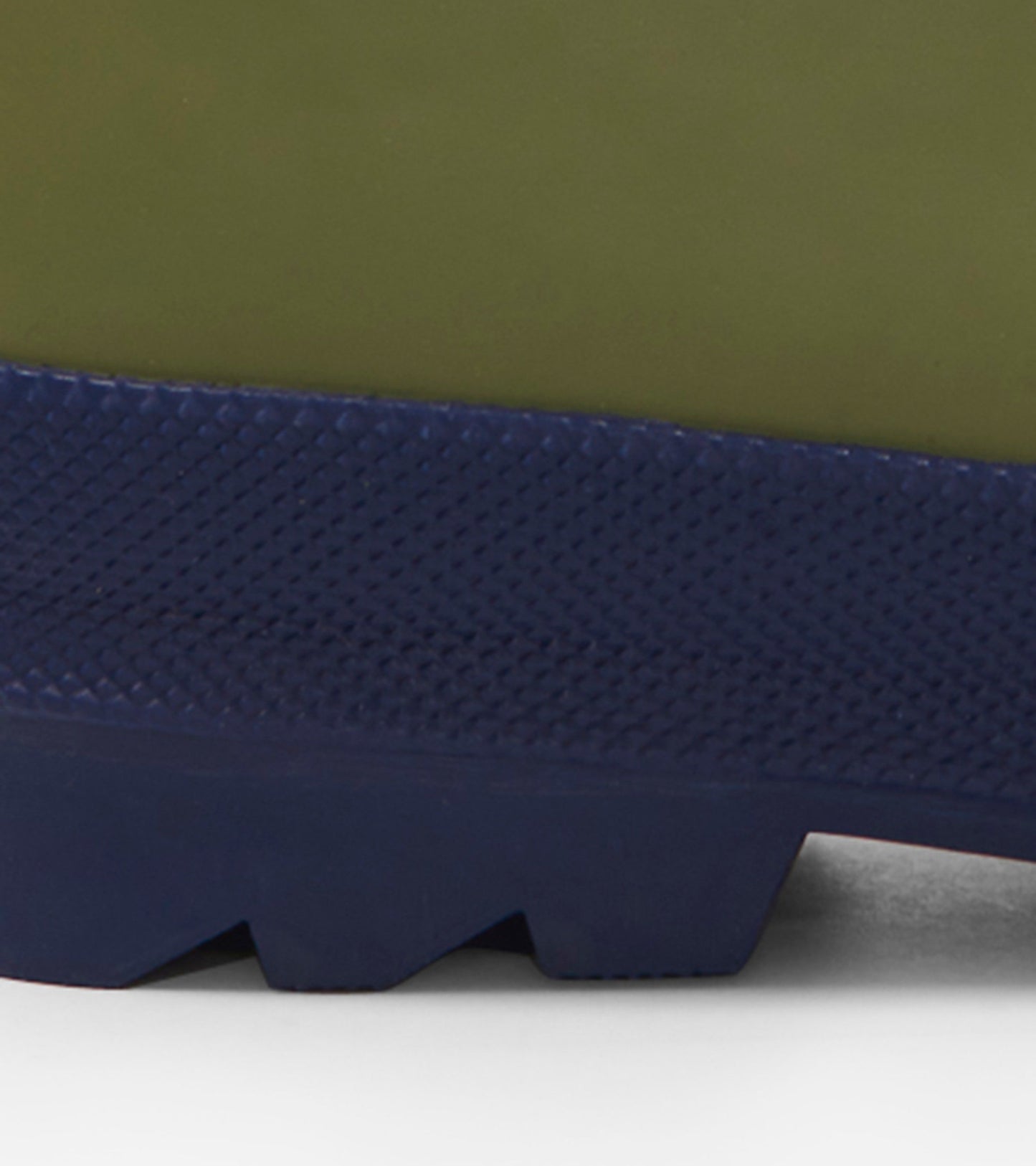 Forest green matte rain boots with a textured navy sole, designed for kids. Ideal for wet weather play.