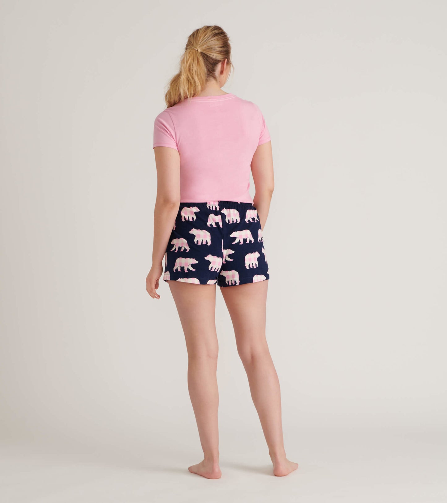 Navy cotton sleep shorts featuring a pink bear pattern, shown from the back with a fitted pink top.