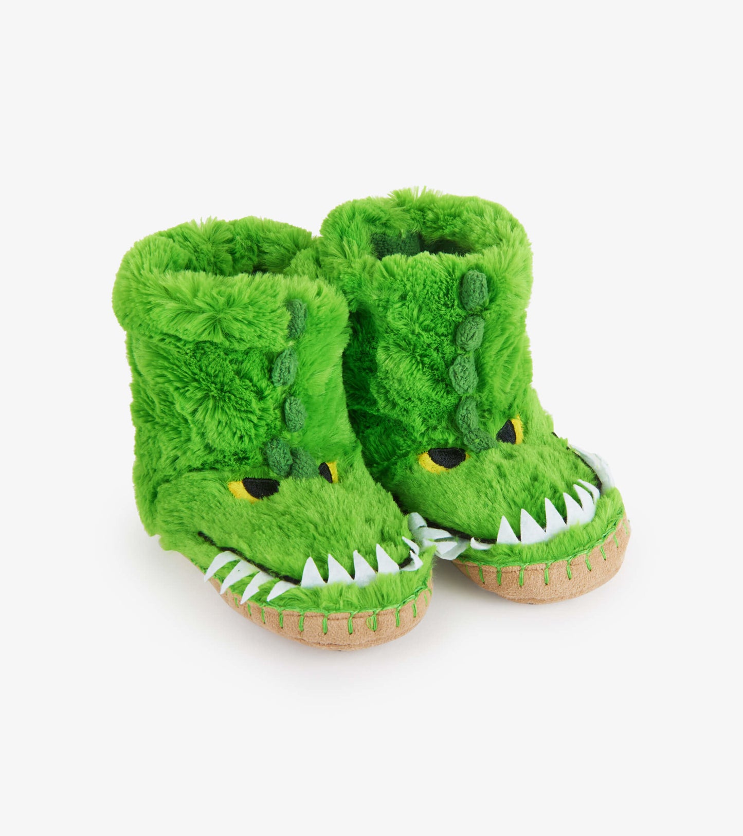 Green fuzzy slouch slippers shaped like an alligator, featuring eyes, teeth, and a soft, plush material.