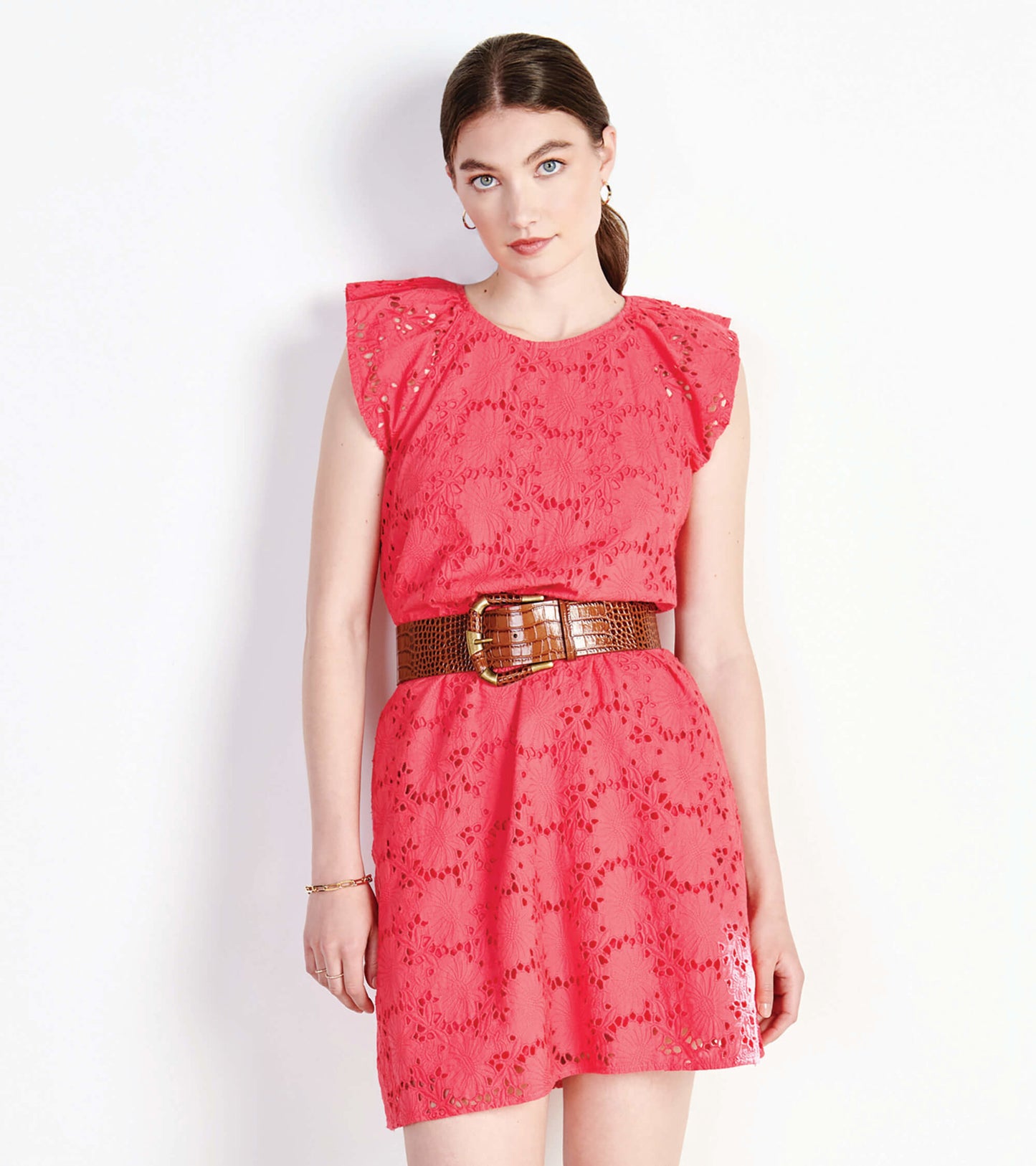 Rouge red eyelet dress with ruffled sleeves and a cinched waist, styled with a brown belt.