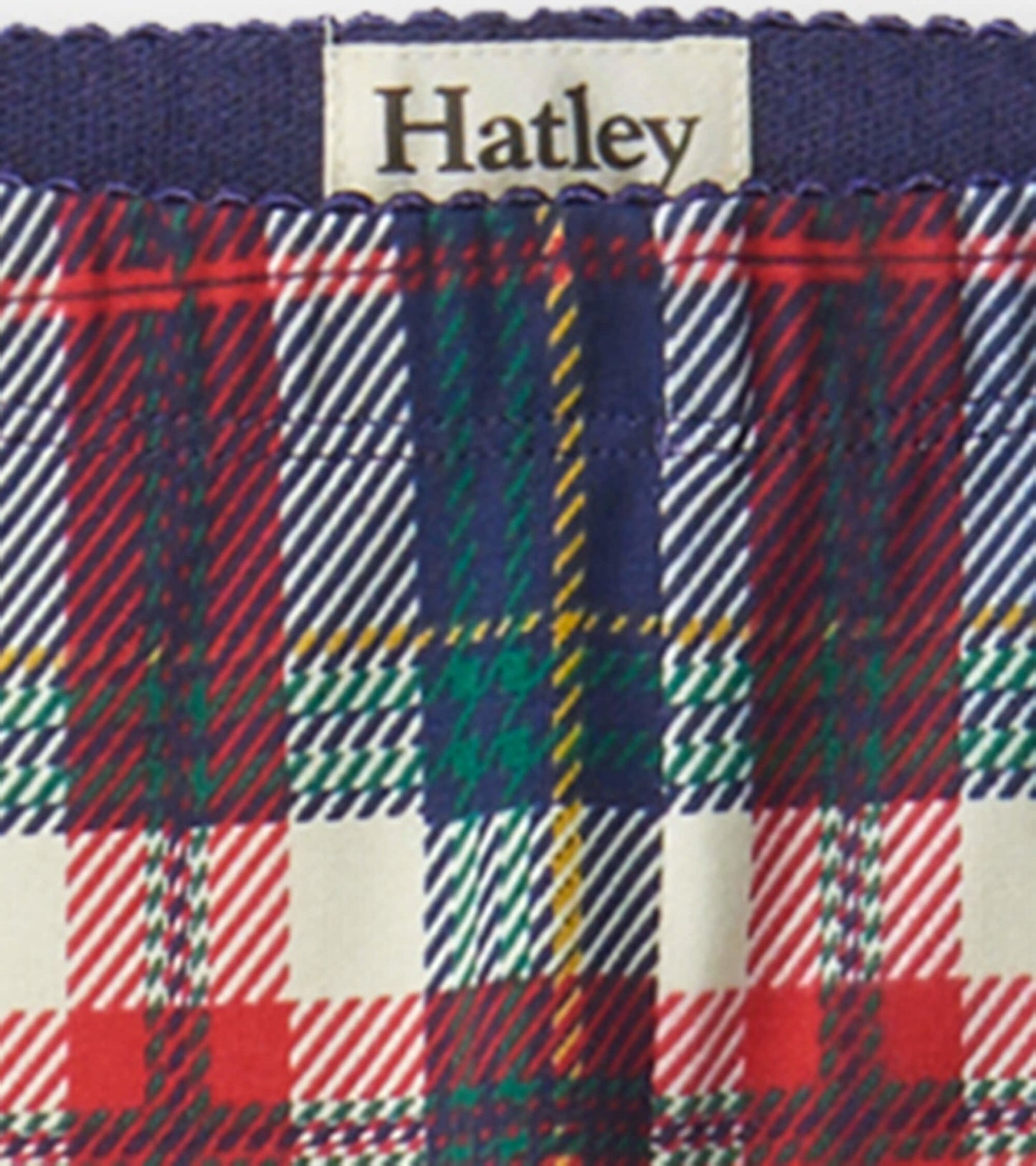 Red, green, and navy plaid leggings with an elastic waistband, suitable for casual wear.