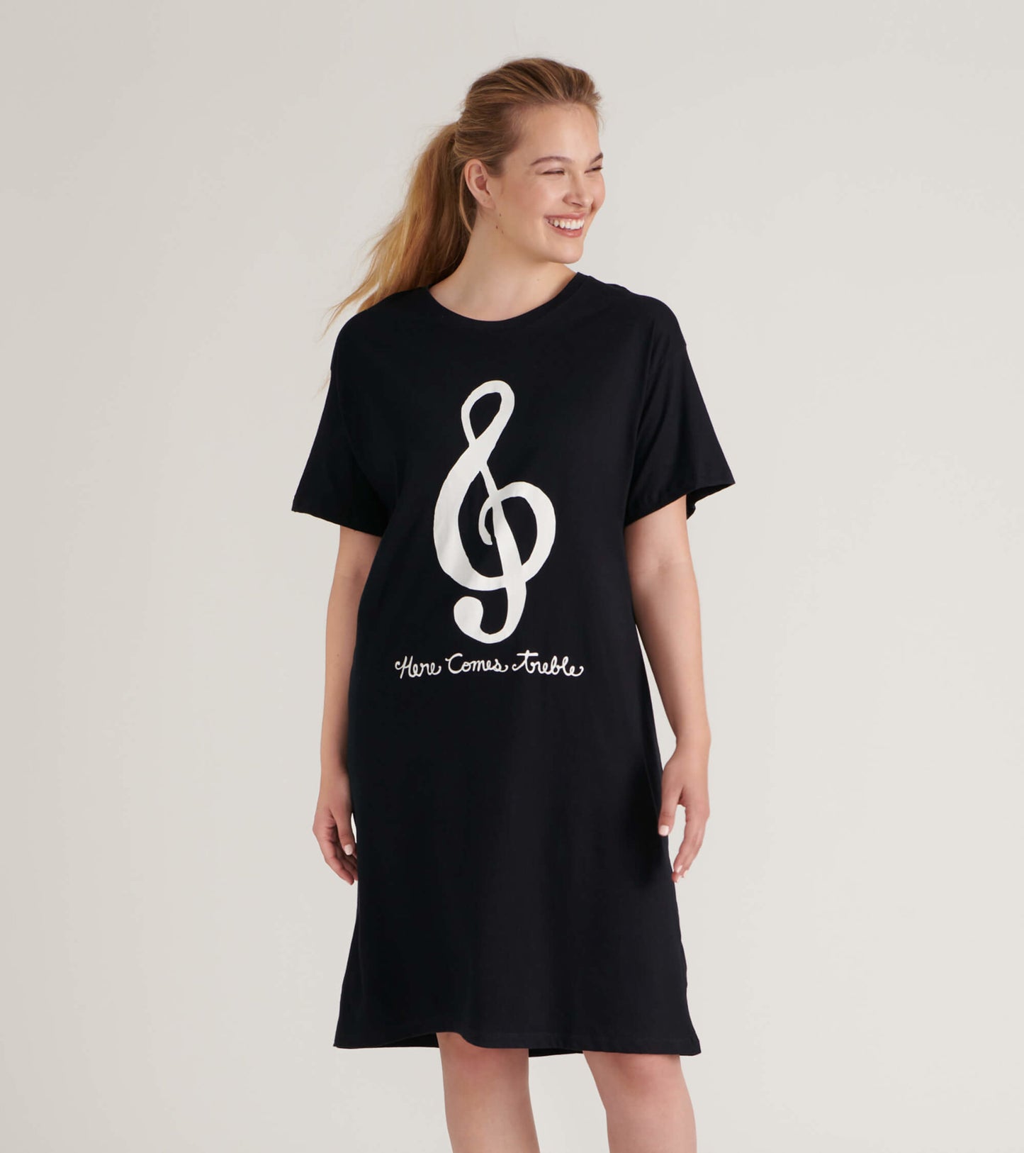 Black short-sleeve sleepshirt featuring a large white treble clef design and text, relaxed fit, knee-length.