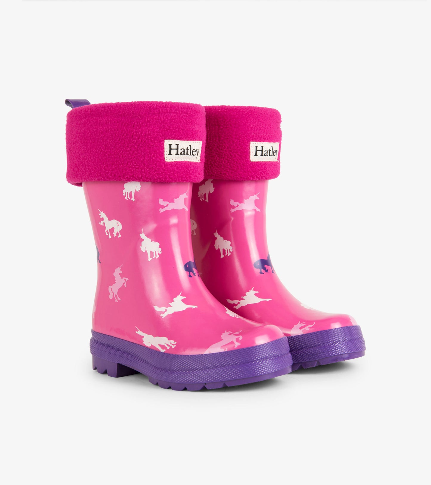 Magenta waterproof kids' boots with unicorn patterns and purple soles, featuring a cozy pink fleece cuff.