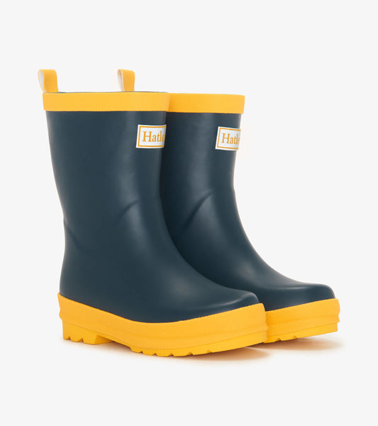 Navy blue matte rain boots with yellow soles and trim, featuring a textured grip for kids.