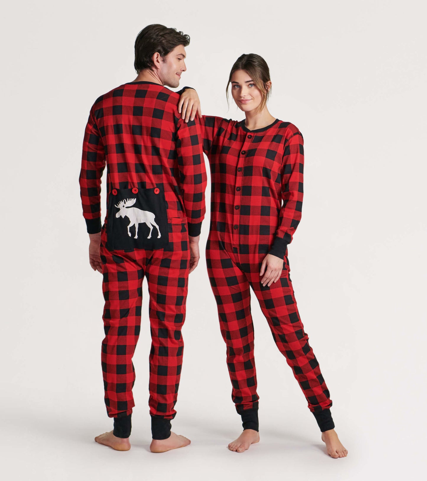 Red and black plaid adult onesie featuring a moose design on the back, with buttons and ribbed cuffs.