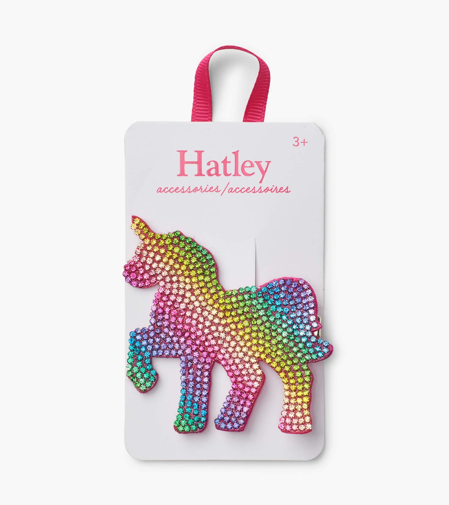 Large unicorn hair clip featuring a rainbow of sparkling rhinestones on a pink background.