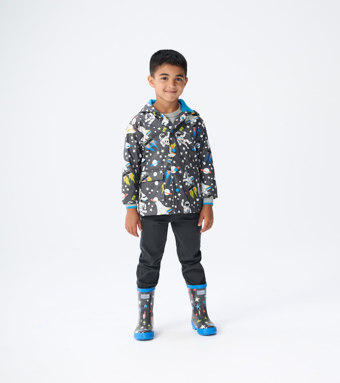 Shiny kids' rain boots in ombre gray with colorful star and space patterns, featuring a blue trim and sturdy sole.