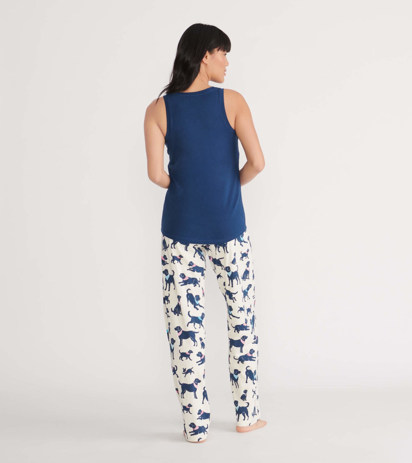Navy tank top paired with white pajama pants featuring a playful dog print, shown from the back.