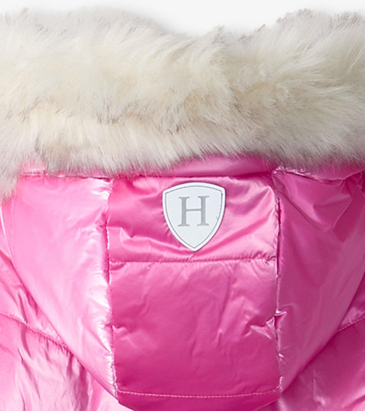 Pink puffer jacket with a faux fur hood and a logo patch on the back, designed for kids.