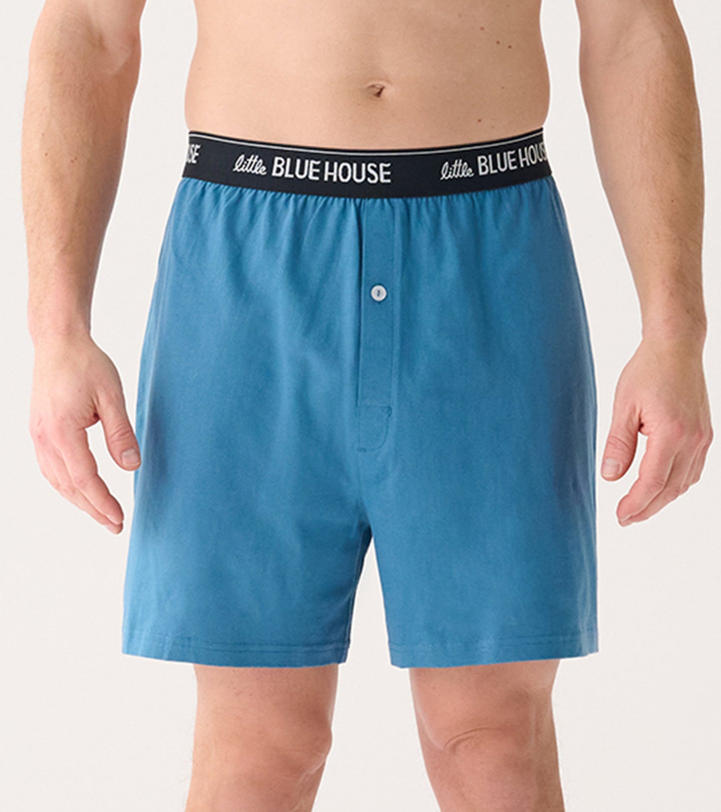 Men's boxer shorts in a solid blue color with a black elastic waistband and a front button closure.
