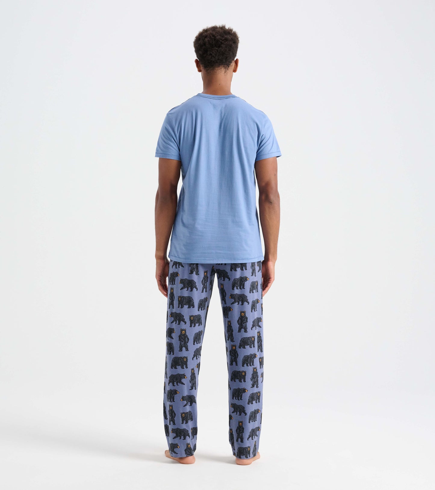 Light blue short-sleeve tee worn with patterned pajama pants featuring bear designs, viewed from the back.