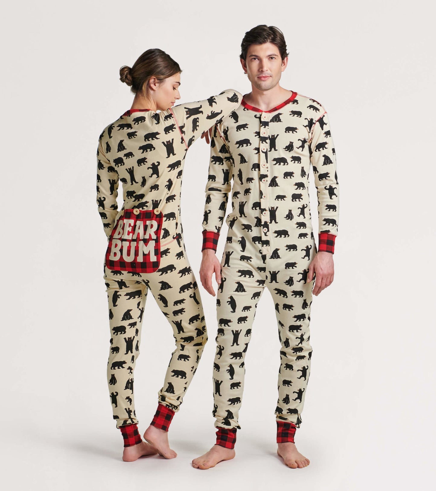 Cream onesie featuring black bear patterns, red plaid accents, and a playful "BEAR BUM" design on the back.