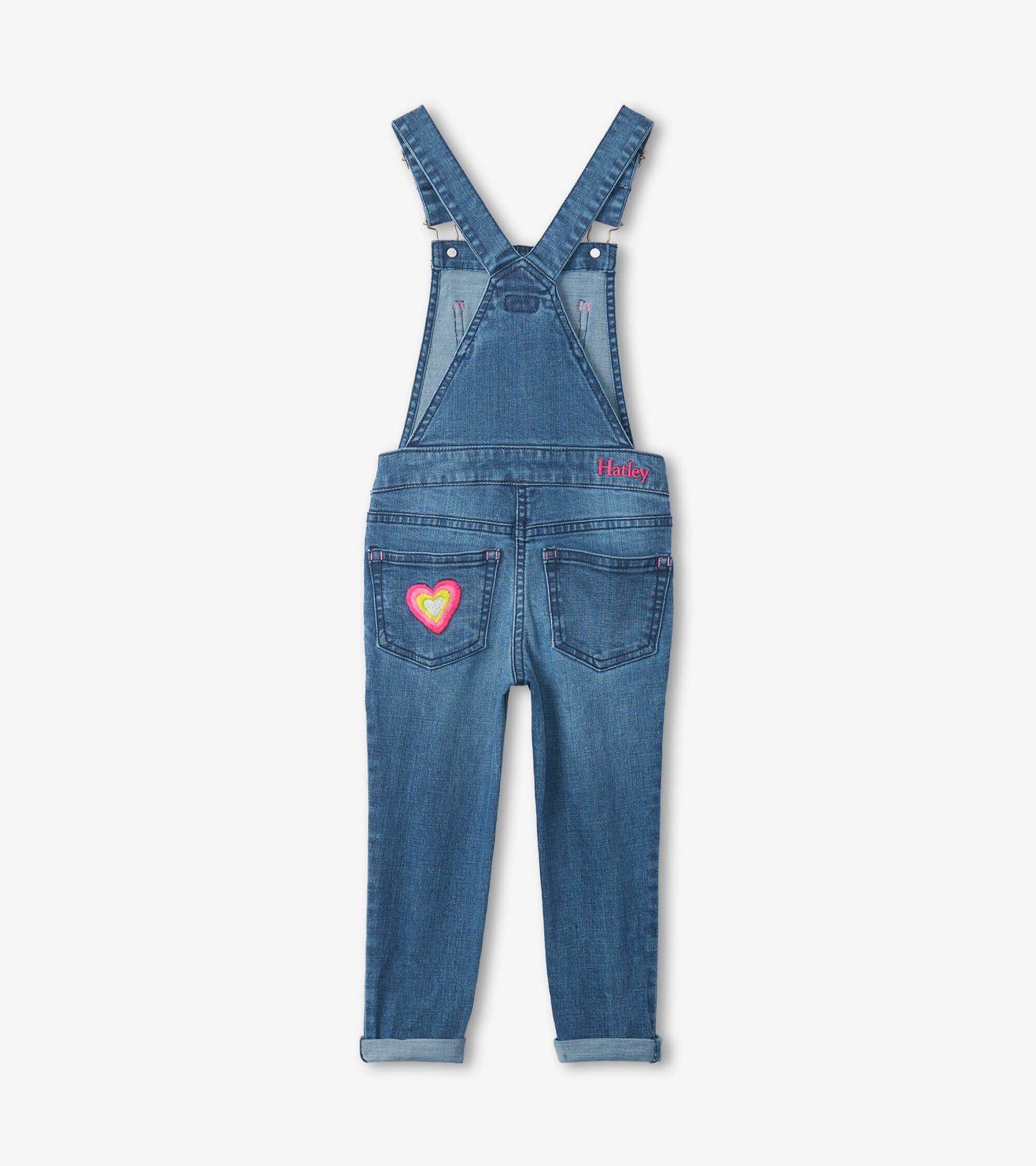 Blue denim stretch overalls with adjustable straps and a colorful heart embroidery on the back pocket.