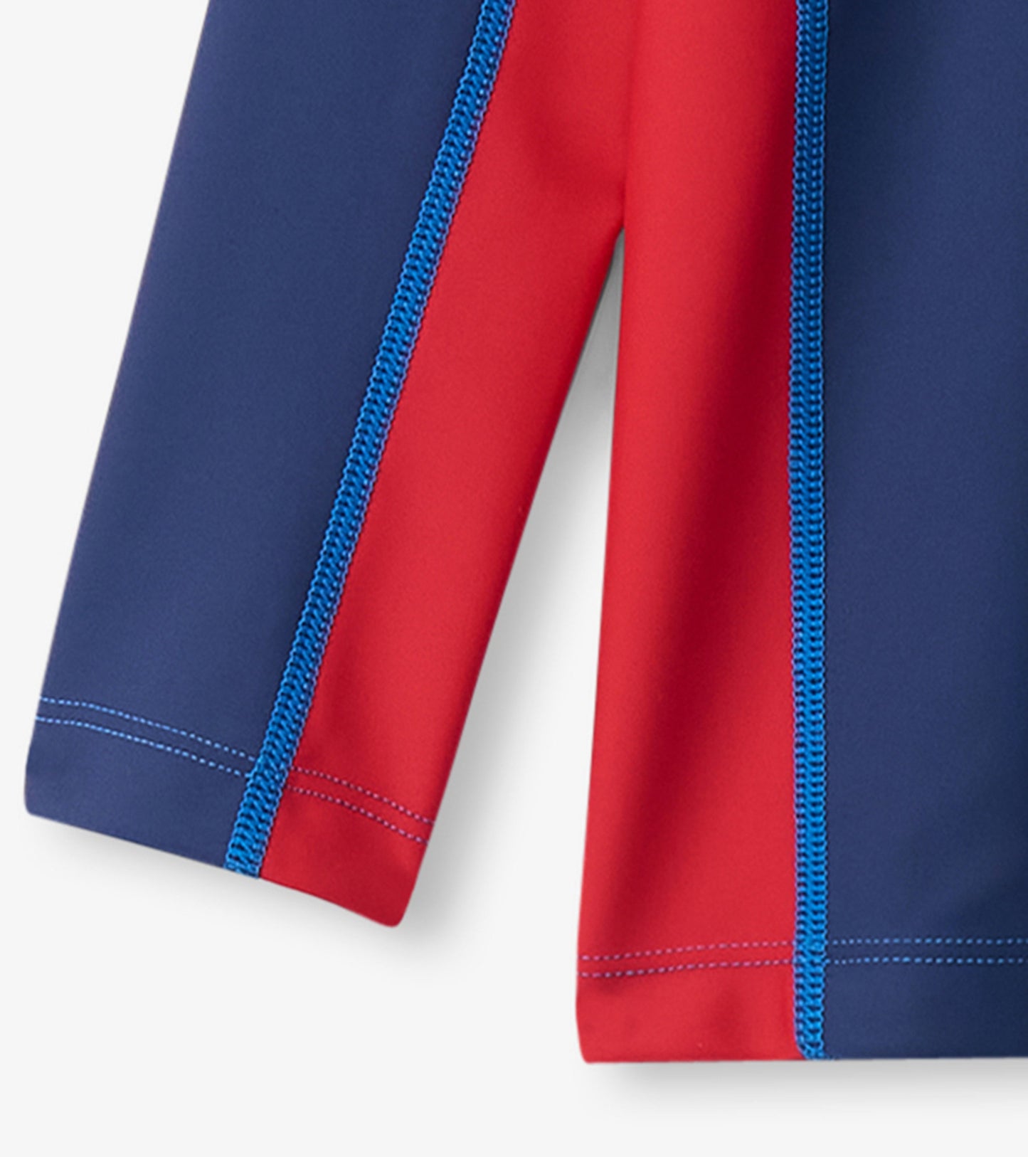 Nautical long sleeve rashguard featuring a colorblock design in navy and red with contrasting blue stitching.