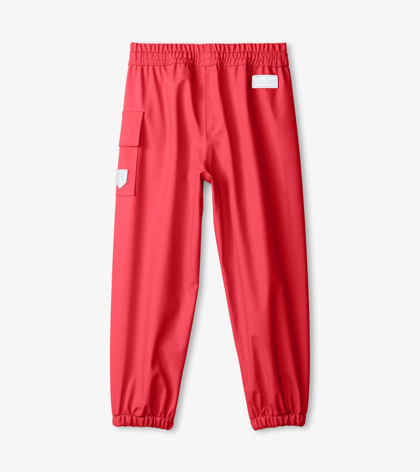 Red waterproof kids' rain pants with elastic waistband and side pocket, designed for outdoor play.