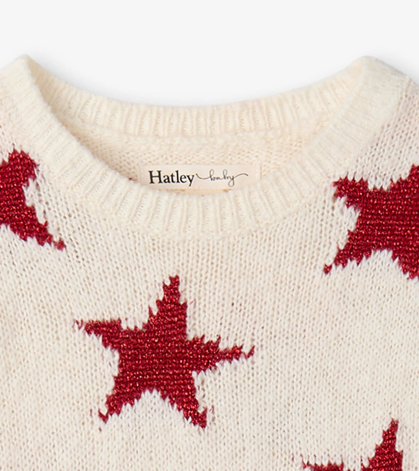 Cream sweater dress featuring red star patterns and a ribbed neckline, suitable for infants and toddlers.