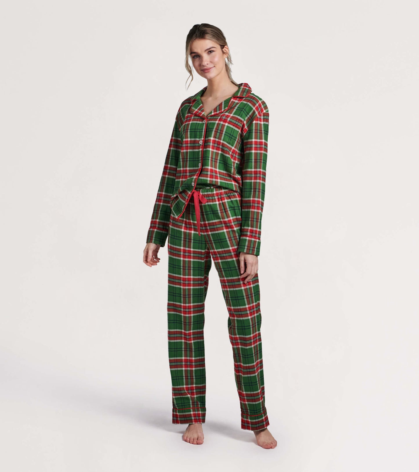 Green and red plaid flannel pajama set with long sleeves, button-up top, and drawstring pants.