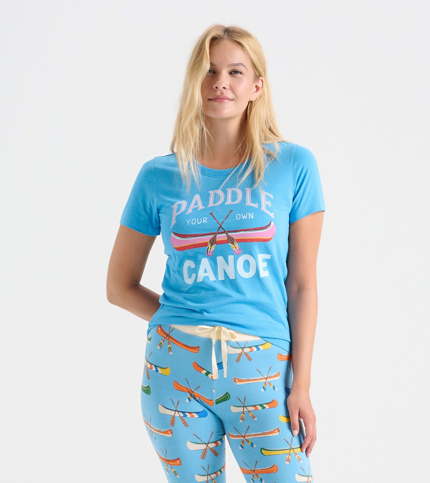 Light blue women's pajama t-shirt featuring a canoe graphic and playful text, paired with matching patterned pants.