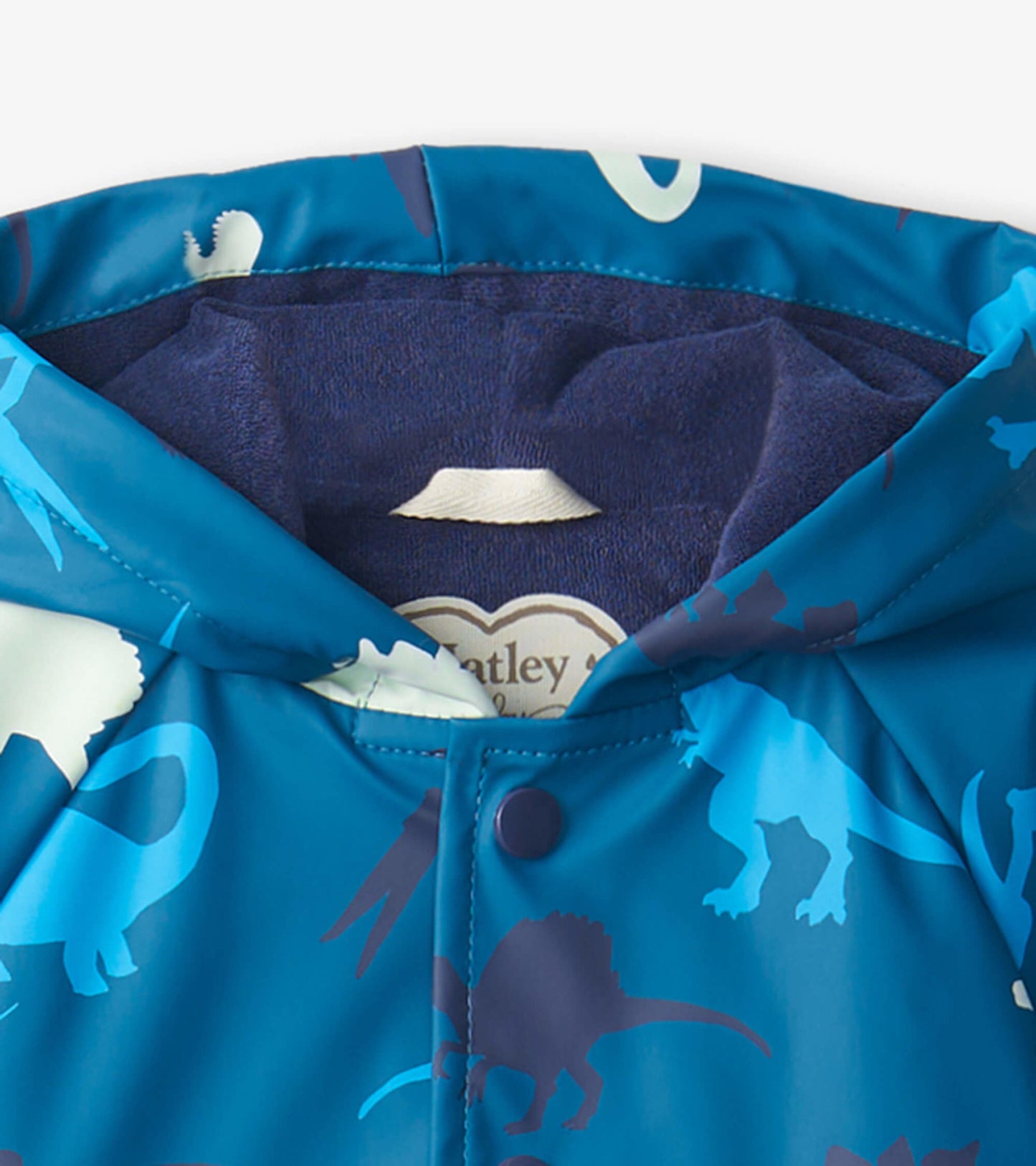 Blue waterproof raincoat with dinosaur patterns, featuring a hood and snap closure, suitable for babies.