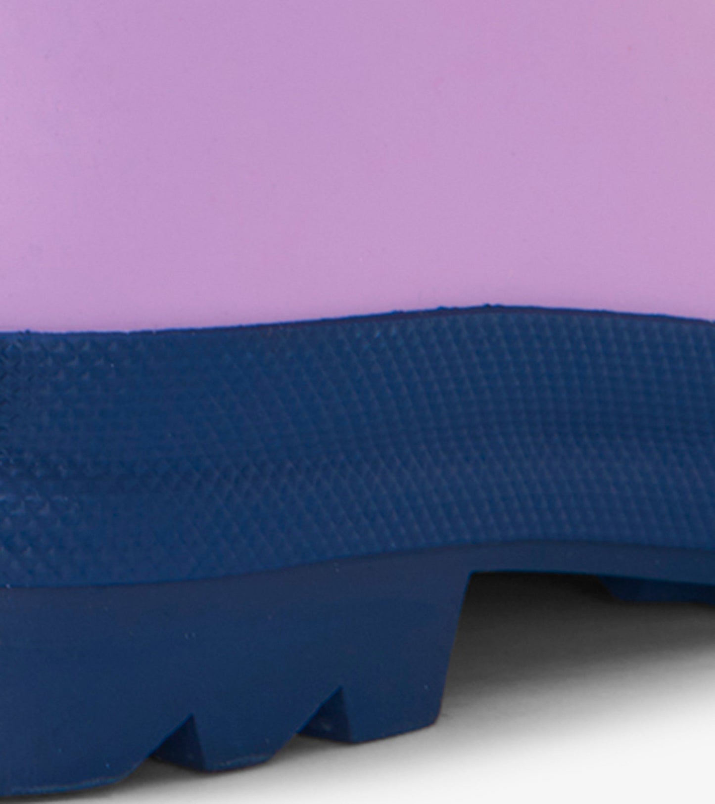 Lilac matte rain boot with a navy rubber sole, featuring a textured finish for grip and durability.