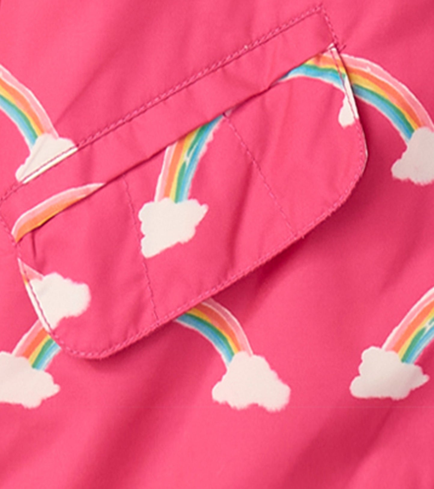 Pink lightweight rain jacket featuring colorful rainbows and clouds pattern. Ideal for summer weather.