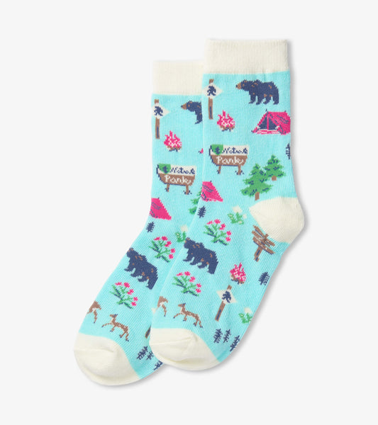 Teal crew socks featuring a camping theme with bears, trees, and tents, designed for kids aged 2-7.