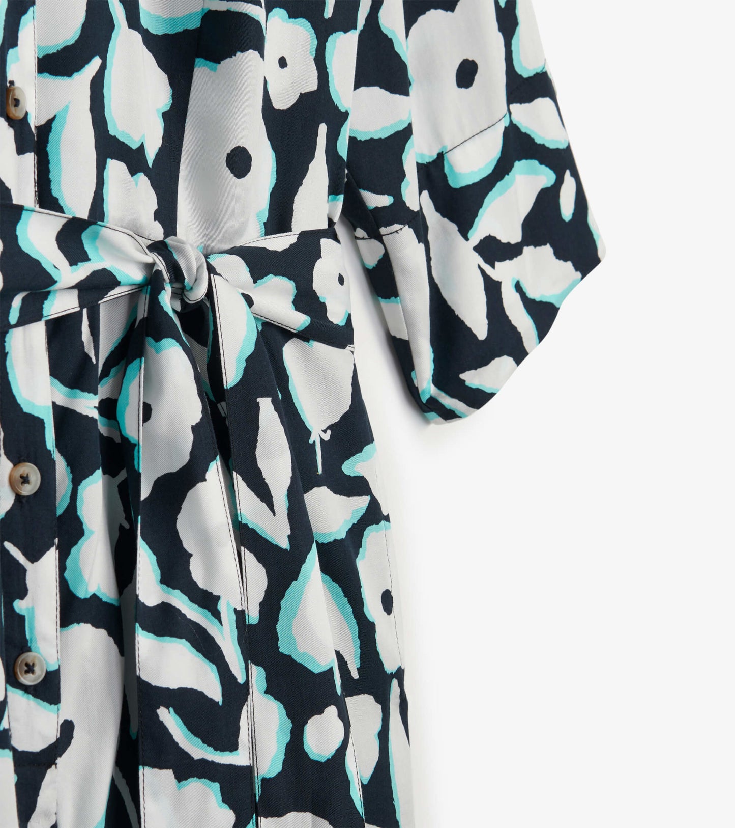 Navy romper with a fresh floral pattern, featuring a tie waist and short sleeves.