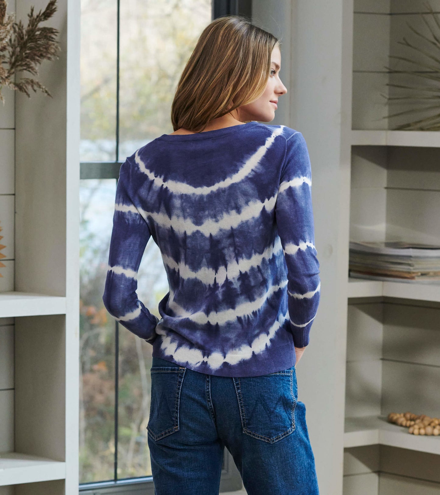Long-sleeve sweater in purple and white tie-dye pattern, featuring a relaxed fit and round neckline, viewed from the back.