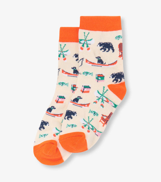 Cream crew socks featuring colorful lake-themed patterns, including bears, canoes, and fishing motifs, with orange cuffs.