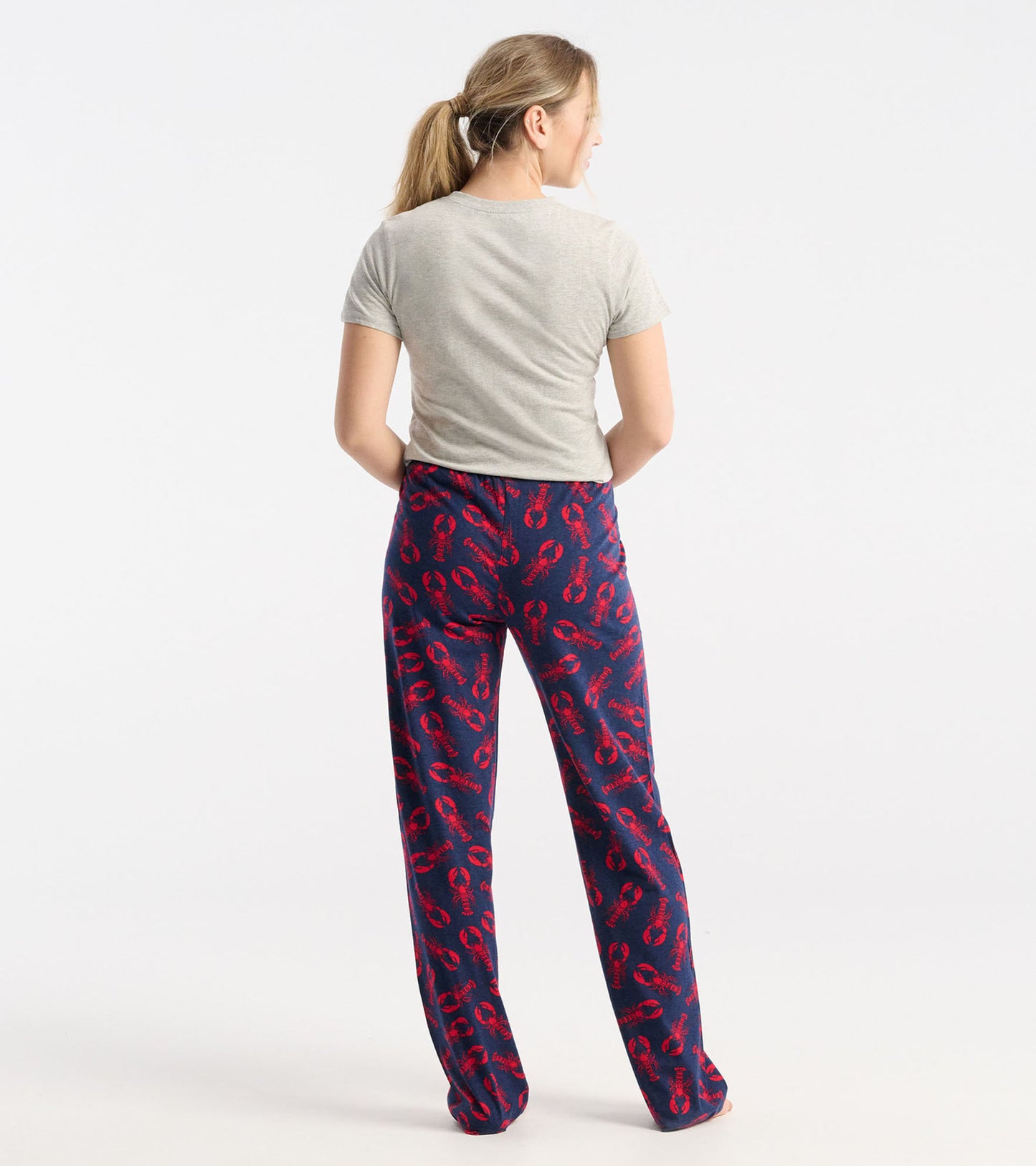 Gray crew neck t-shirt worn with patterned lobster-print pants, viewed from the back.