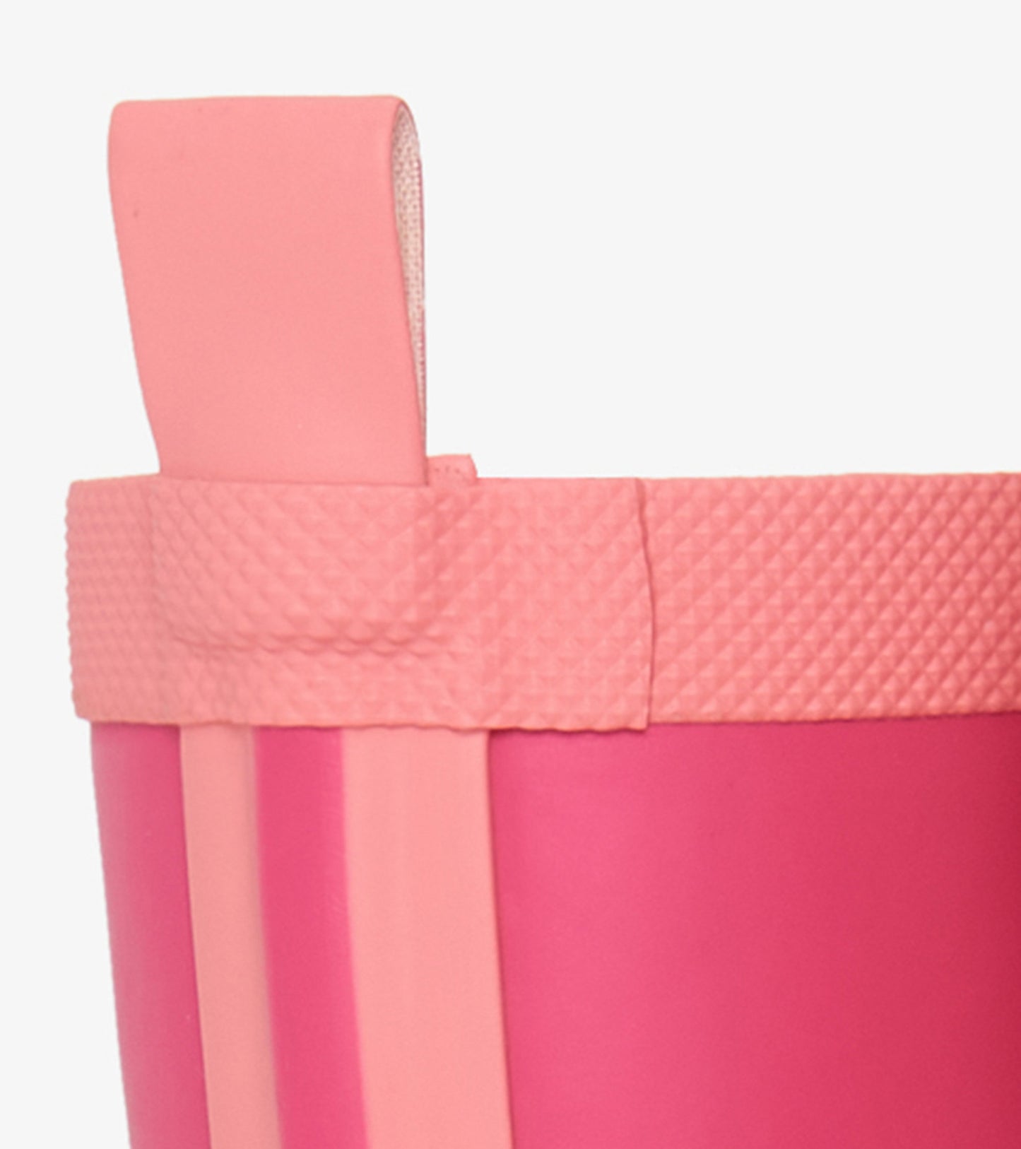 Pink matte rain boot with textured top and pull tab, designed for kids. Ideal for wet weather and outdoor play.