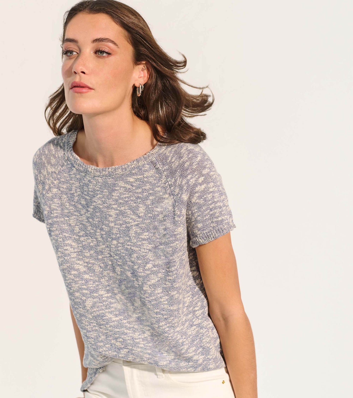 Short-sleeve knit tee in a soft blue and cream speckled pattern, featuring a relaxed fit and round neckline.
