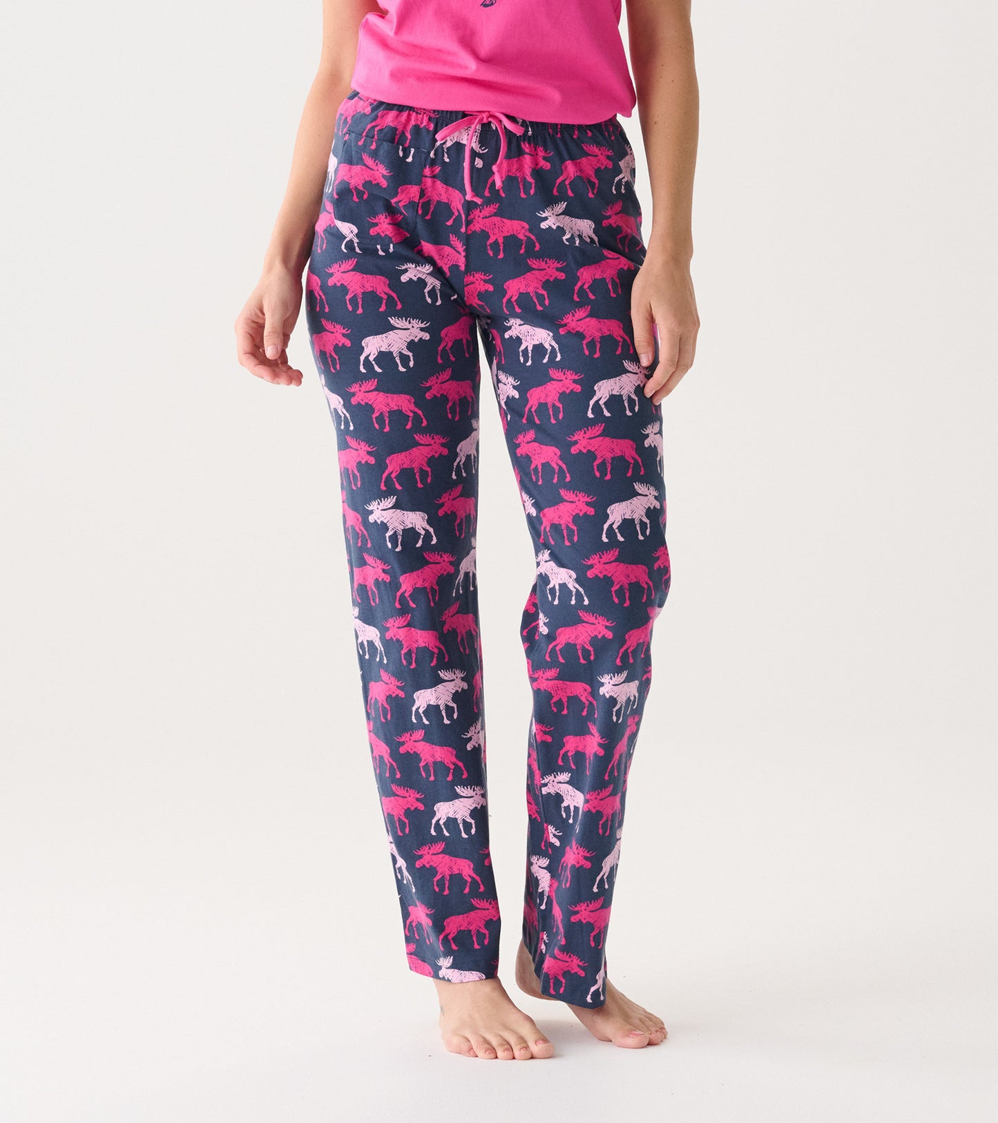 Navy cotton pajama pants featuring a playful moose pattern in pink and white, with an elastic waistband and drawstring.