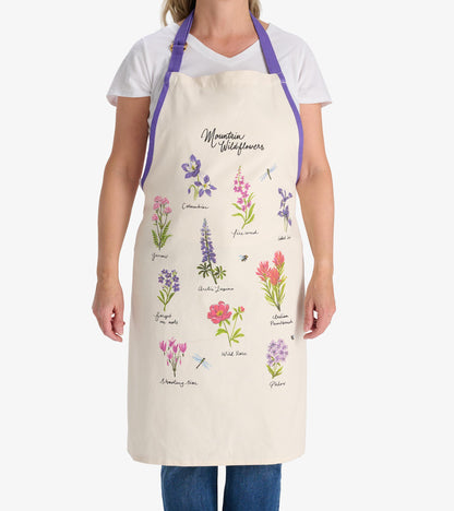Cream apron featuring colorful wildflower illustrations and a purple neck strap, ideal for cooking or crafting.