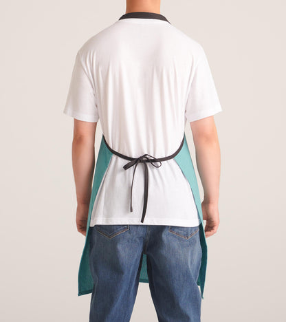 Teal apron with a black neck strap, tied at the back, worn over a white shirt and jeans.