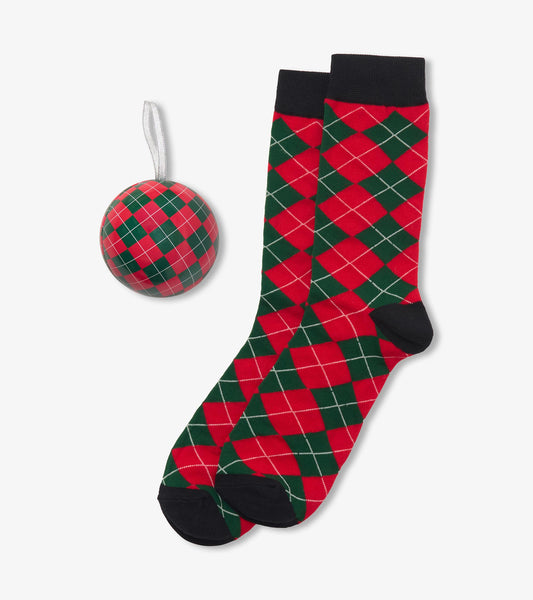 Red and green argyle crew socks with black cuffs beside a matching ornament ball