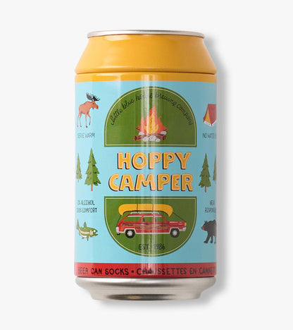 Beer can-shaped socks package with camping graphics and the words Hoppy Camper on a blue label