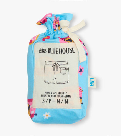 Folded blue pajama shorts with colorful retro camper and floral print, tied with cream ribbon, in a fabric pouch