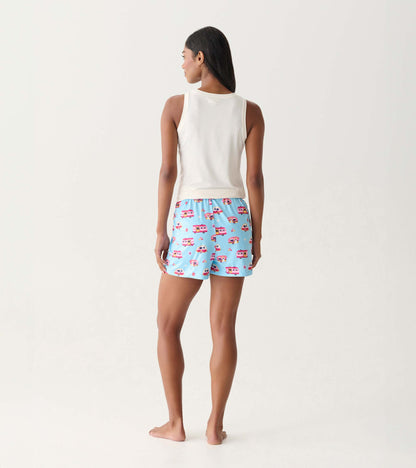 Back view of light blue pajama shorts with colorful camper print, worn with a white tank top.