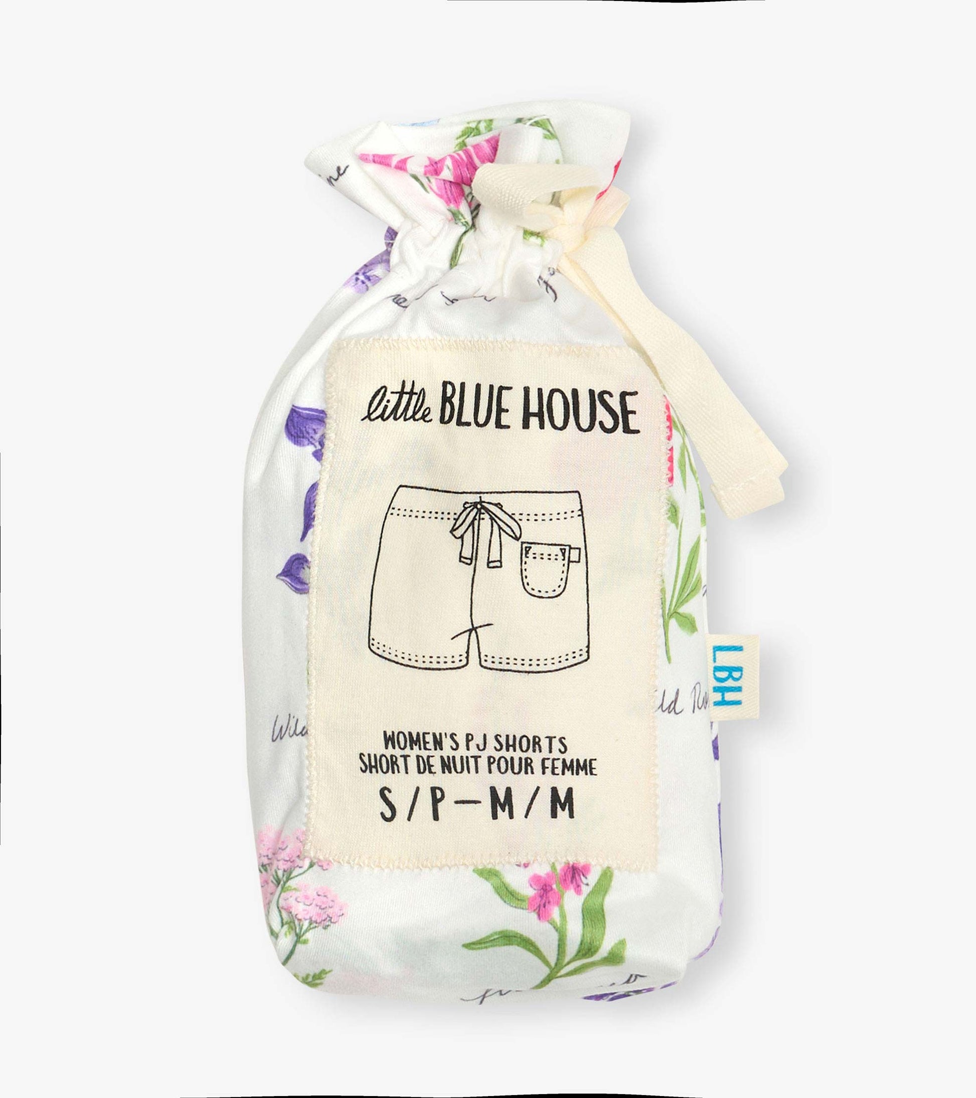Folded white pajama shorts with colorful wildflower print and cream drawstring pouch label