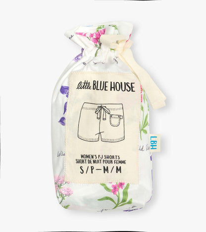 Folded white pajama shorts with colorful wildflower print and cream drawstring pouch label