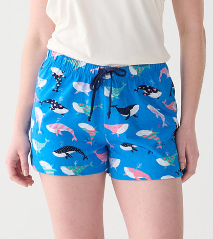 Close-up of blue boxers with multicolored whale print, elastic waist, and navy drawstring