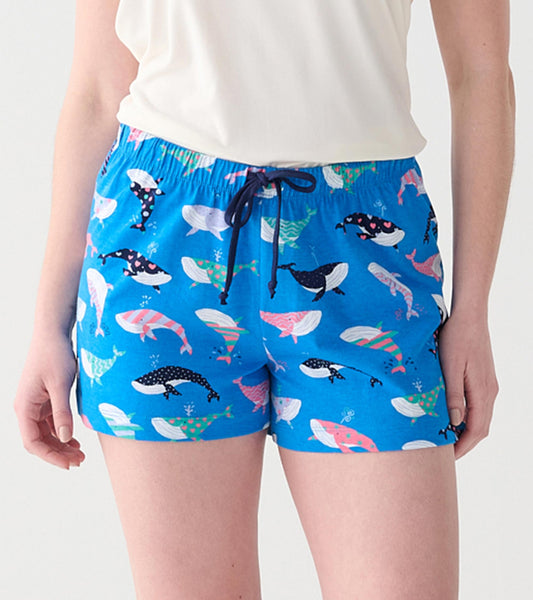 Close-up of blue boxers with multicolored whale print, elastic waist, and navy drawstring