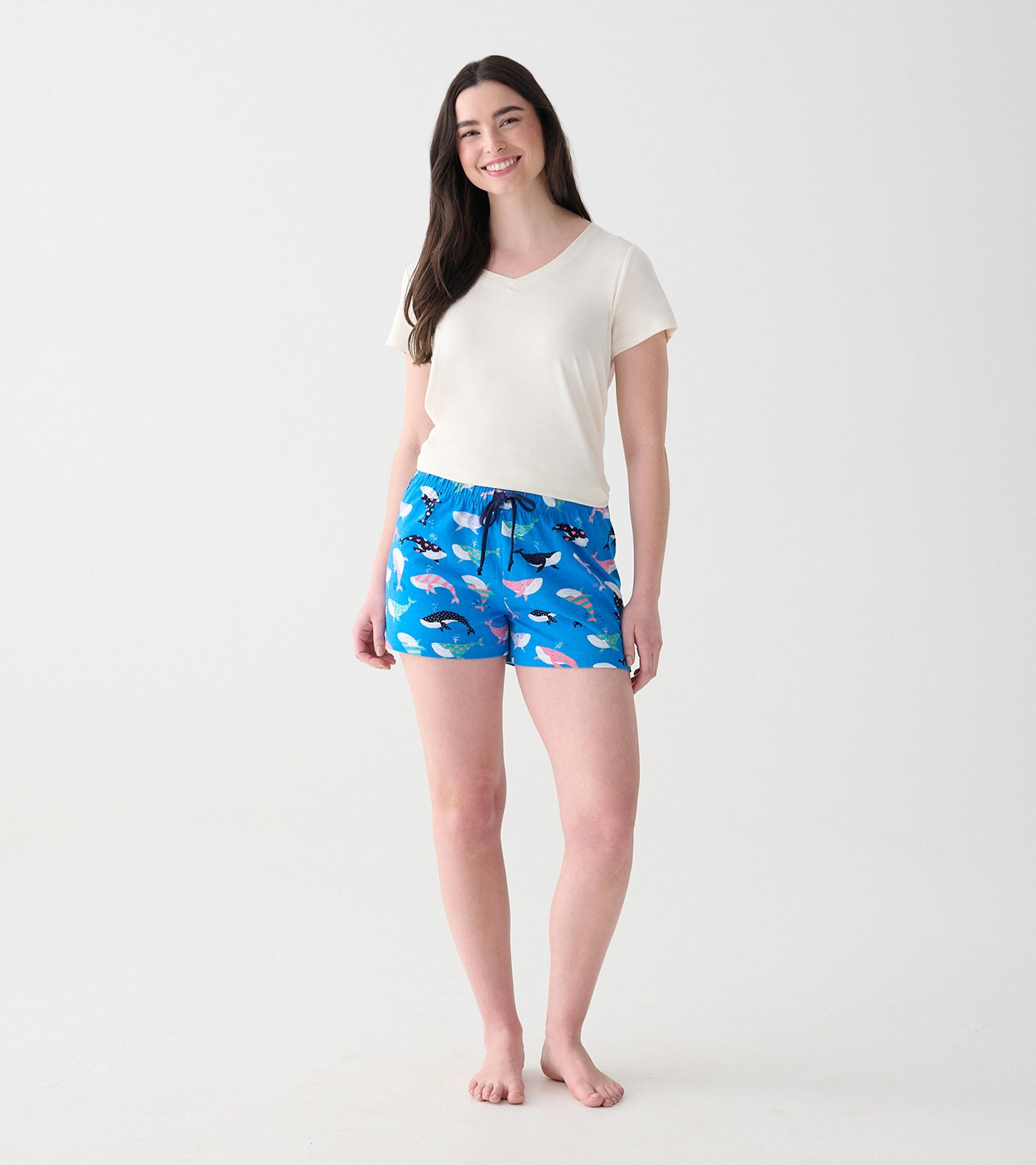 Front view of model wearing blue whale-print boxers with navy drawstring