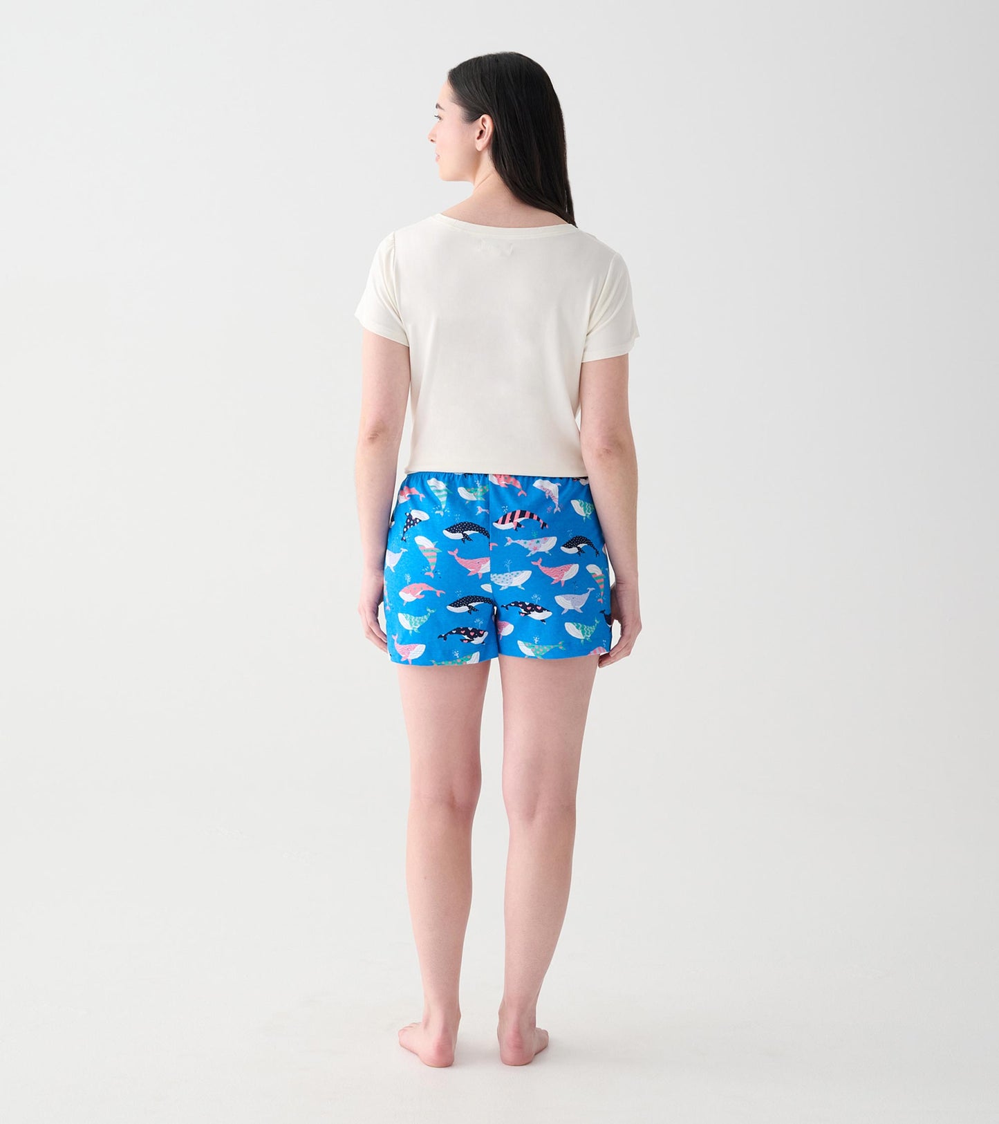 Back view of model wearing blue boxers with multicolored whale print