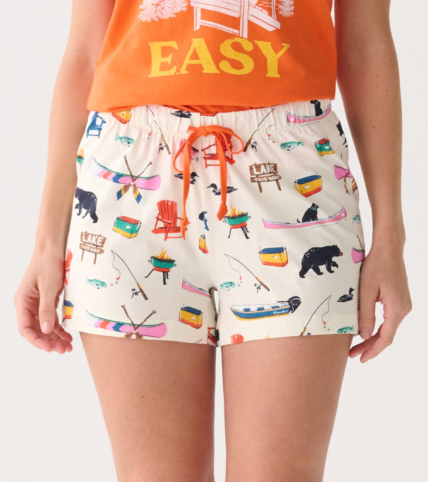 Cotton sleep shorts featuring a playful lake-themed pattern with fishing, bears, and canoes, finished with an adjustable dra…