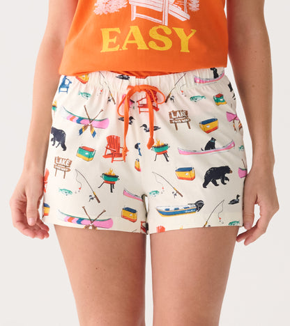 Cotton sleep shorts featuring a playful lake-themed pattern with fishing, bears, and canoes, finished with an adjustable dra…