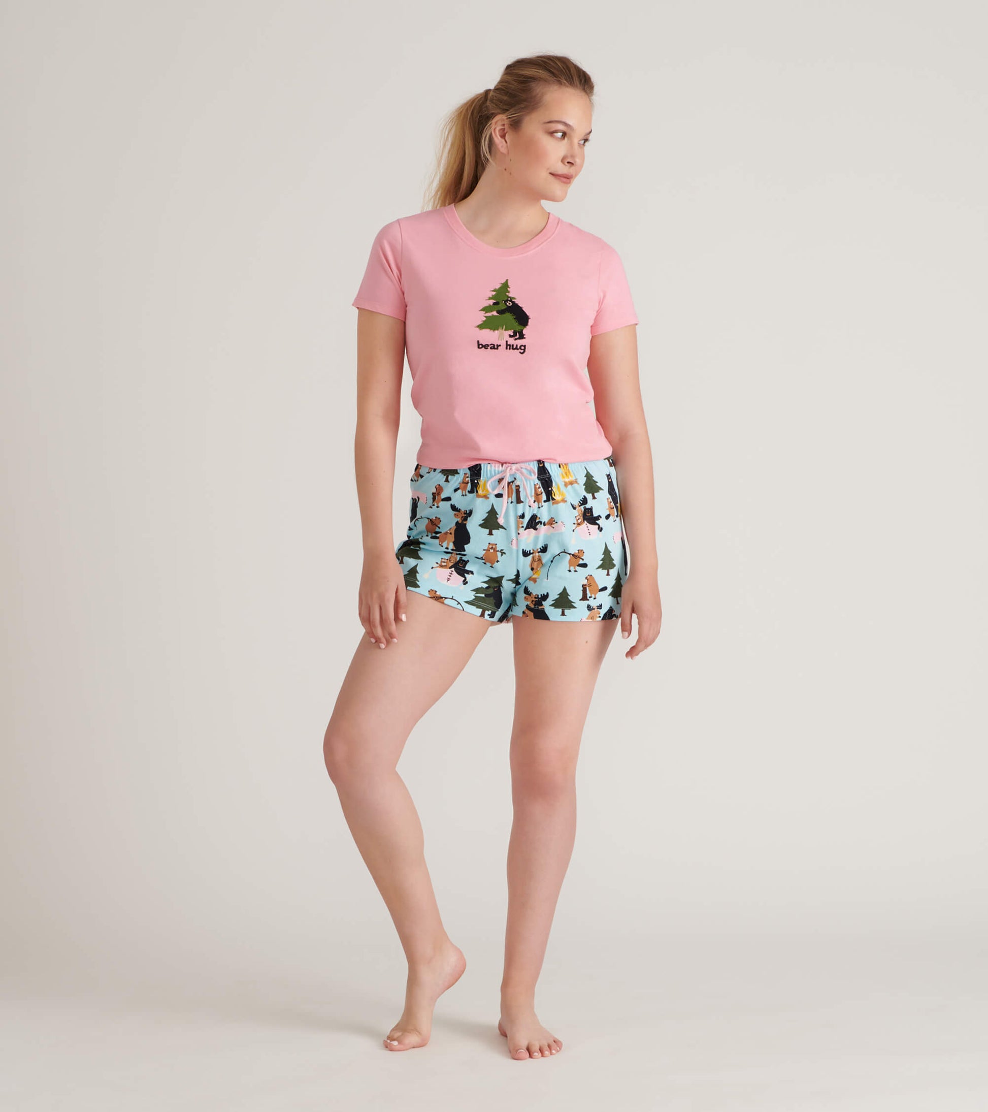 Front view of blue printed sleep shorts worn with a pink T-shirt