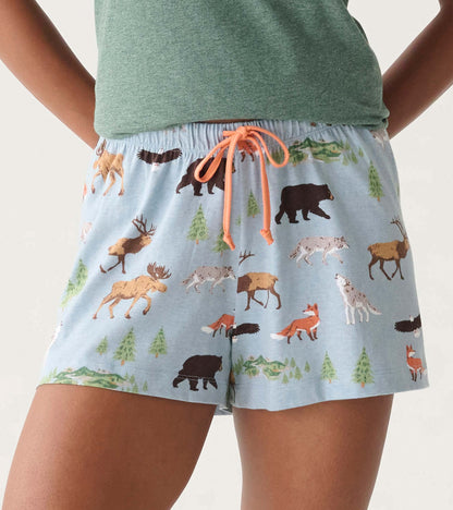 Light blue pajama shorts with wildlife and pine tree print, orange drawstring, front view