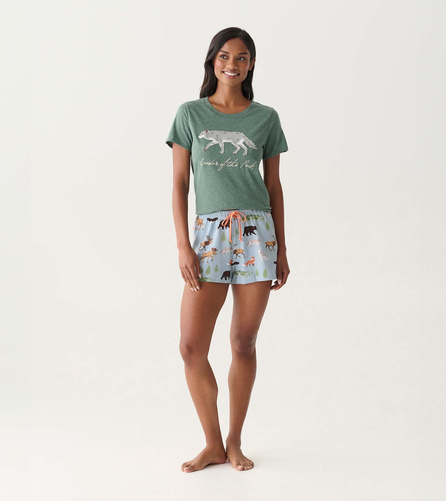 Light blue pajama shorts with a woodland animal print and orange drawstring, shown on a model.